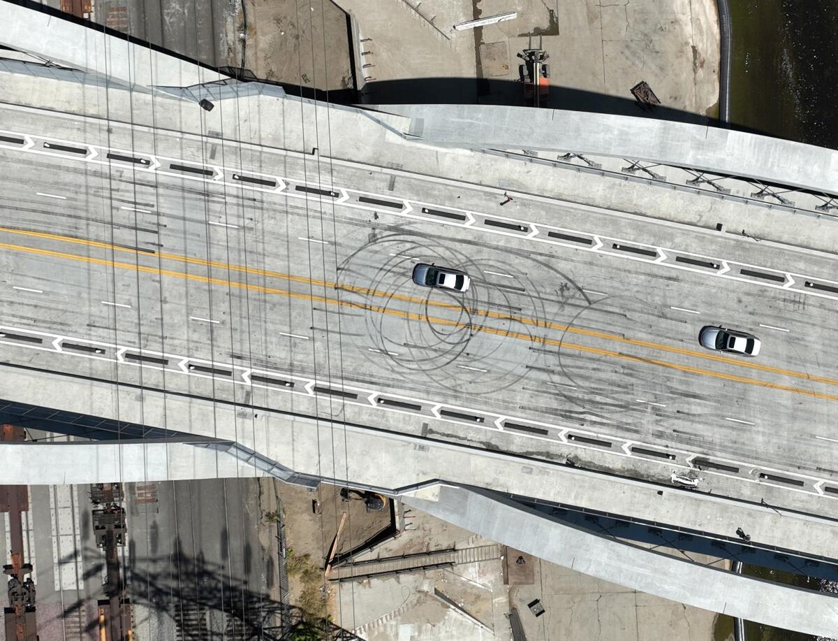 An aerial view of the 6th Street Viaduct roadway with circular tire marks 
