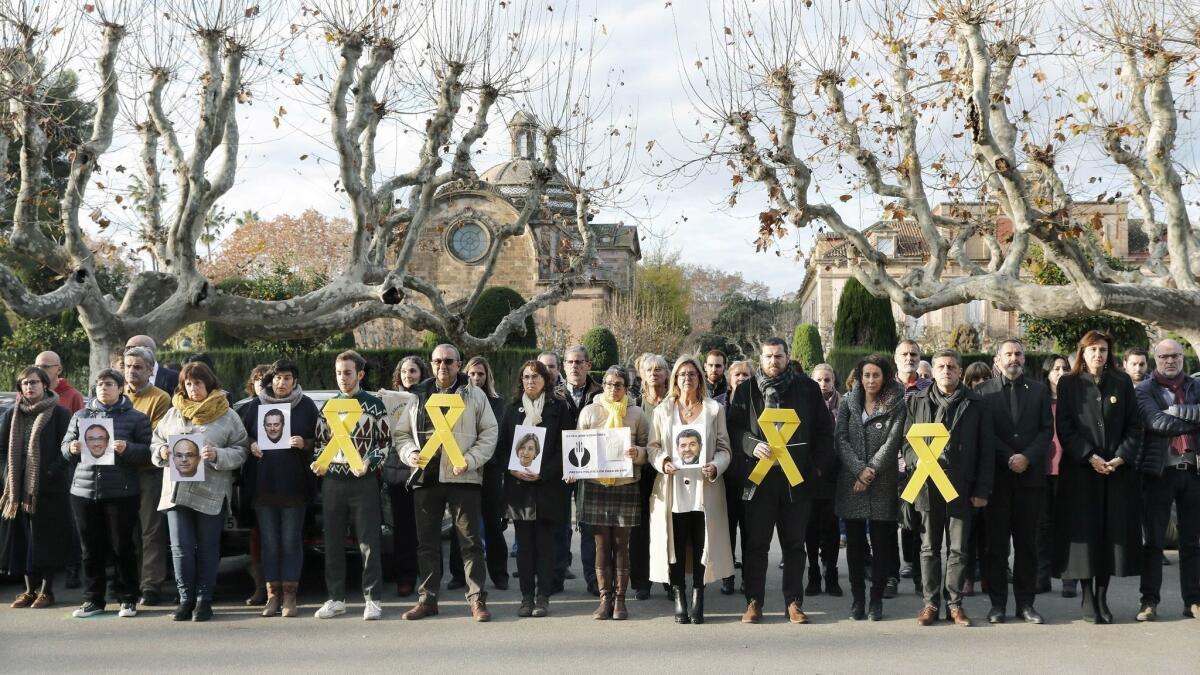 Catalan regional Parliament staff members and pro-independence MPs, displaying yellow ribbons and the portraits of imprisoned Catalan pro-independence political and social leaders, in a demonstration last month in Barcelona.