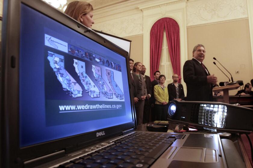 Gabino Aguirre, right, of the California Citizens Redistricting Commission discusses redistricting maps at a Sacramento news conference in 2011.