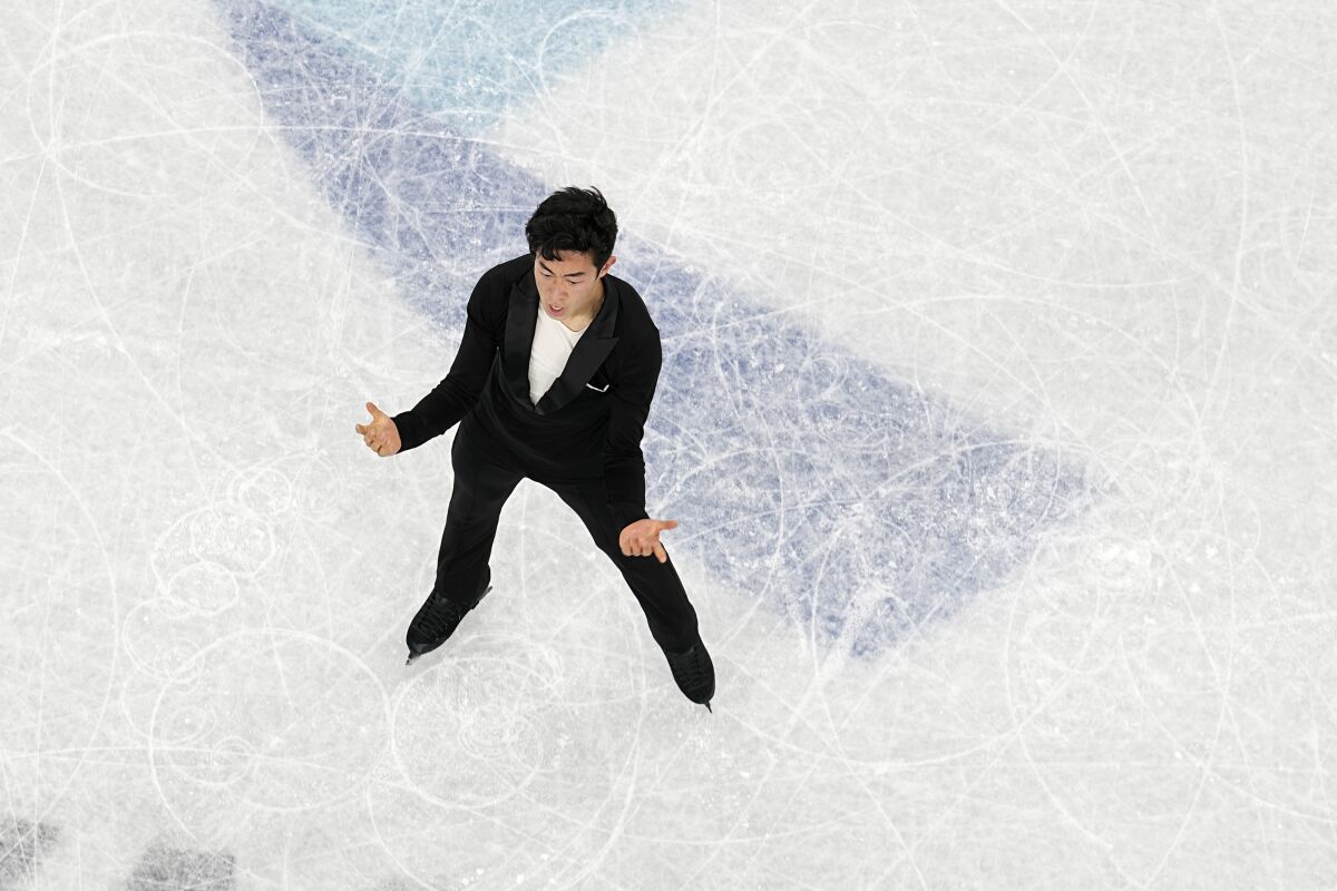 Nathan Chen, of the United States, competes during the men's singles short program team event in the figure skating competition at the 2022 Winter Olympics, Friday, Feb. 4, 2022, in Beijing. (AP Photo/Jeff Roberson)