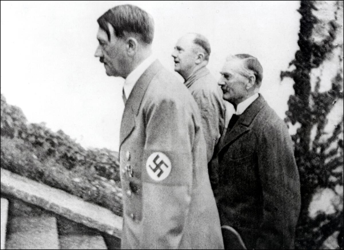 British Prime Minister Neville Chamberlain, right, with Adolf Hitler.