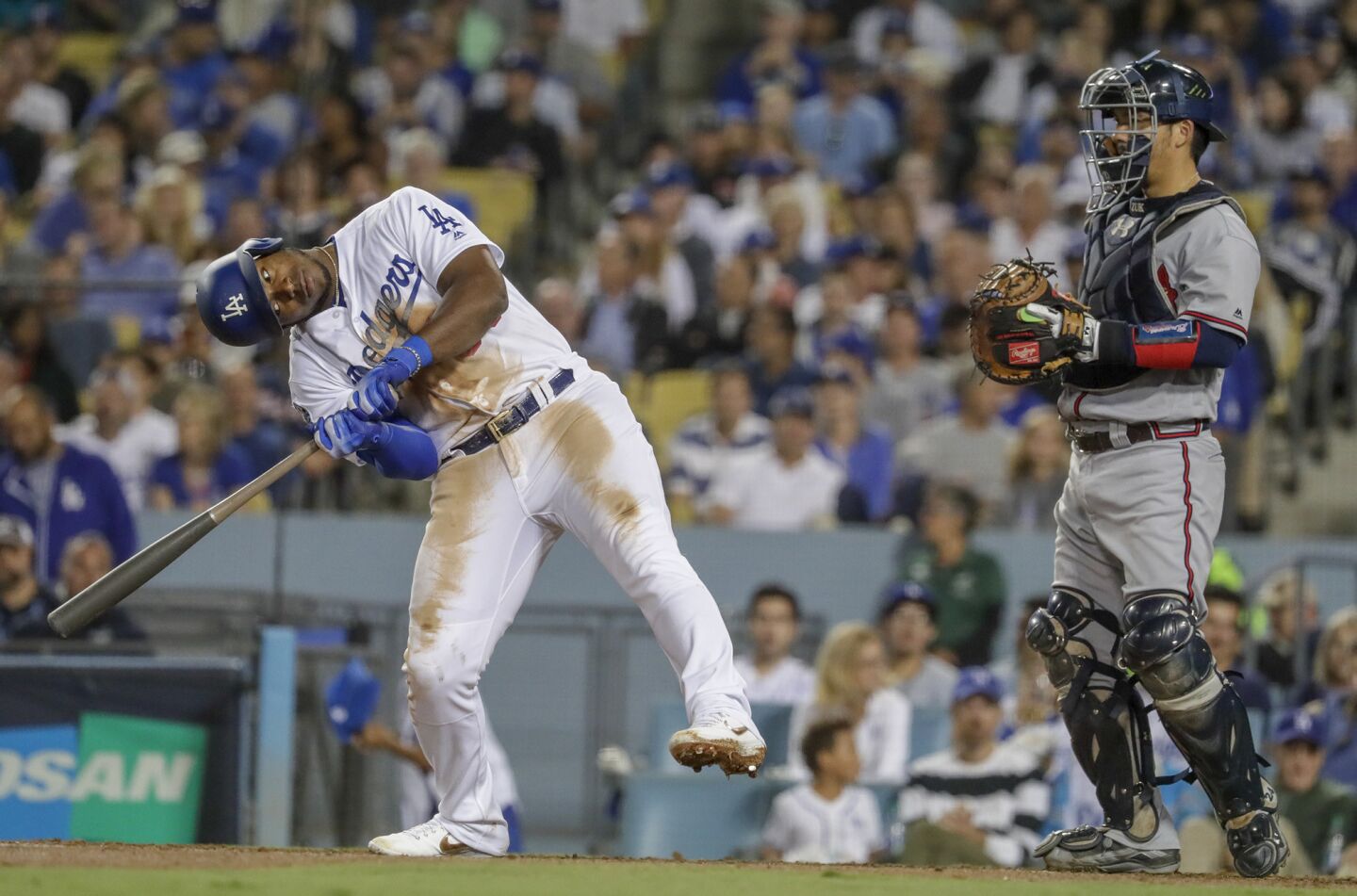 Dodgers right fielder Yasiel Puig contorts his body after fouling off a pitch against Braves reliever Touki Toussaint in the sixth inning.