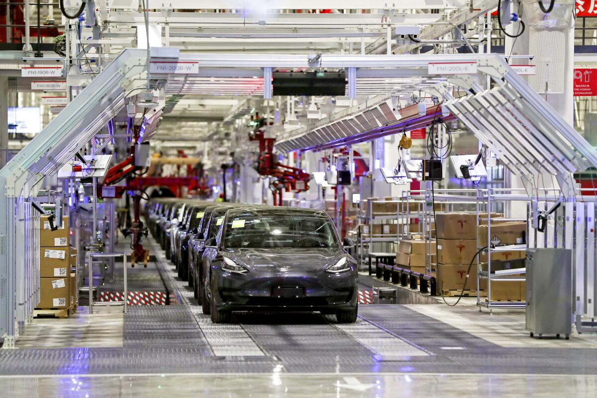 Teslas on an assembly line