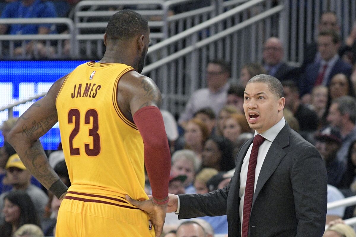 Cavaliers coach Tyronn Lue talks with forward LeBron James during a game in 2017.