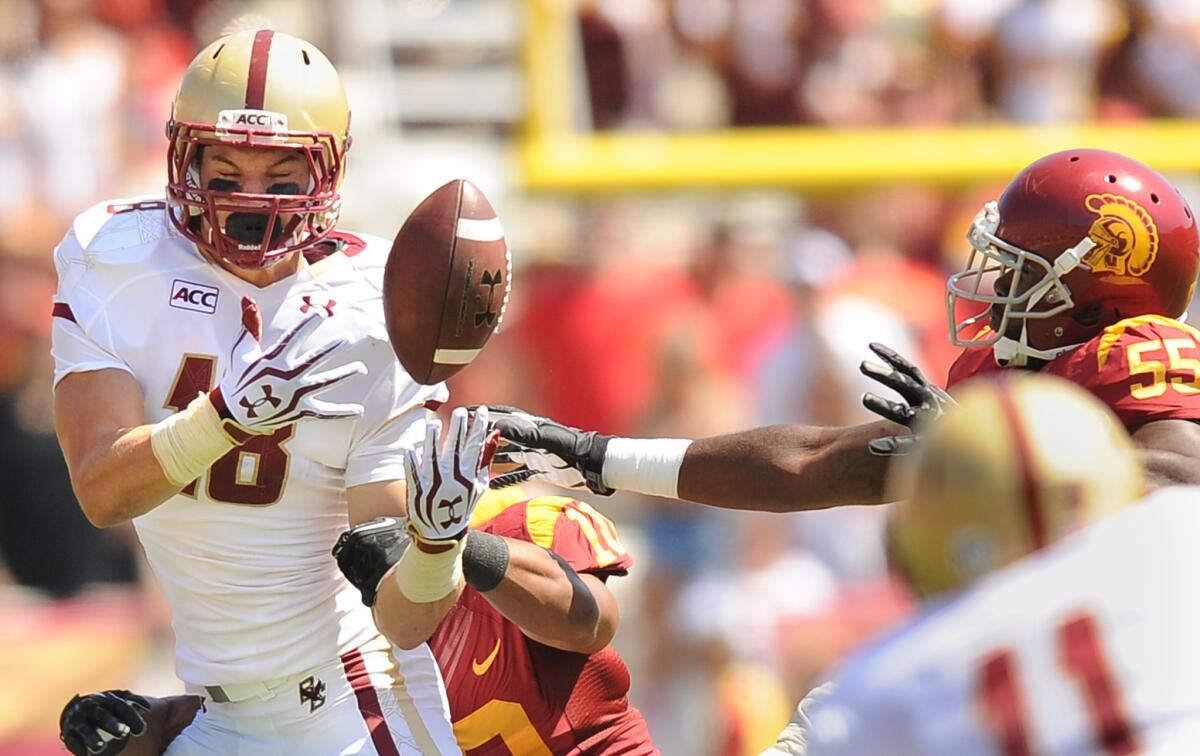 USC's Hayes Pullard, left, breaks up a pass intended for Boston College receiver Dan Crimmins as Lamar Dawson helps on defense in the second quarter at the Coliseum.