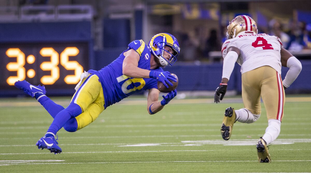  Rams  receiver Cooper Kupp makes a diving catch despite coverage by 49ers cornerback Emmanuel Moseley.
