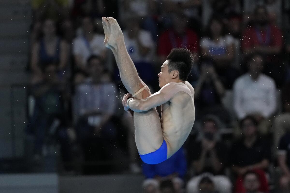 China's Cao Yuan competes in the Olympic men's 10-meter platform diving semifinals on Saturday.