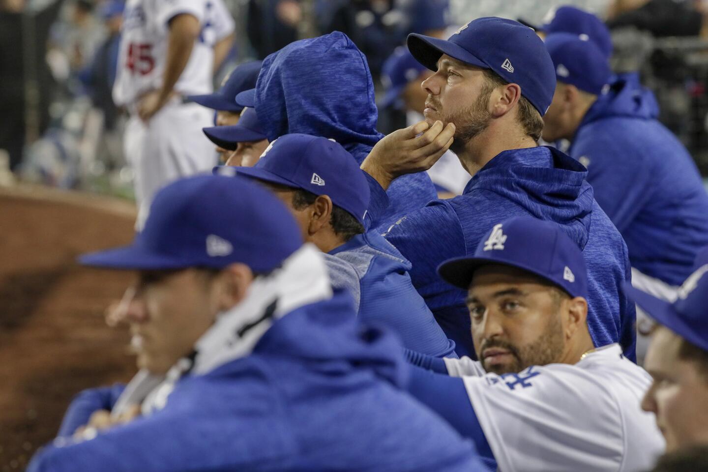 Dodgers players look on from the bench as the Red Sox carry a 5-1 lead late in game five.
