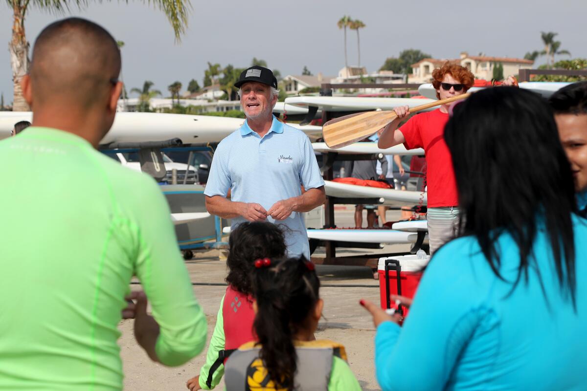 Miracles for Kids board member Tom Swanecamp speaks to participants on Thursday at Newport Aquatic Center in Newport Beach.