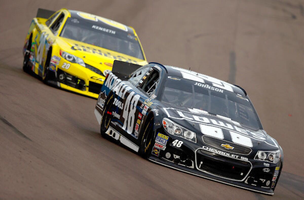 Jimmie Johnson, driver of the No. 48 Lowe's/Kobalt Tools Chevrolet, leads Matt Kenseth, driver of the No. 20 Dollar General Toyota, during the NASCAR Sprint Cup Series AdvoCare 500 at Phoenix International Raceway on Sunday.