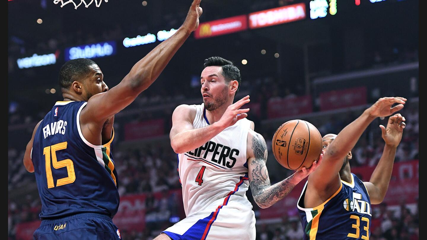 Clippers guard J.J. Redick attempts a pass between Jazz forwards Derrick Flavors, left, and Boris Diaw during the first quarter.