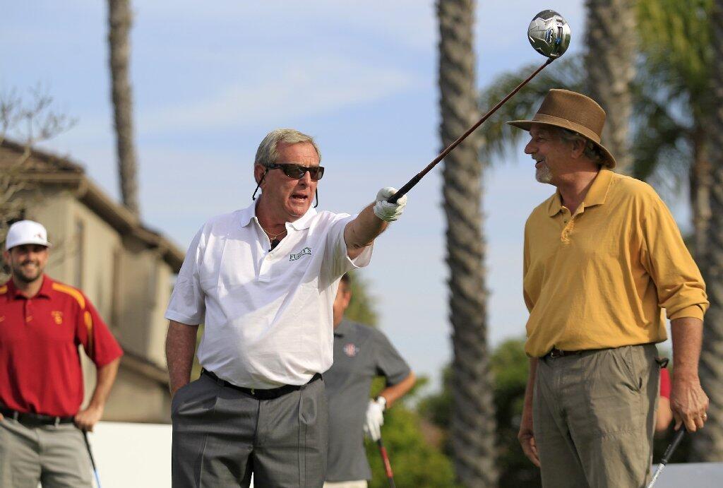 Team USC's Fuzzy Zoeller, left, advises teammate Paul Westphal before Westphal tees off during the second annual Toshiba Classic Skills Challenge at Newport Beach Country Club on Tuesday.