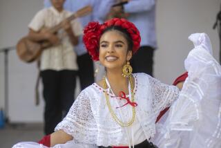 Ayleen Martinez, of BF Cielito Lindo de Simi Valley dances on the tarima while Los Hermanos Herrera play on stage