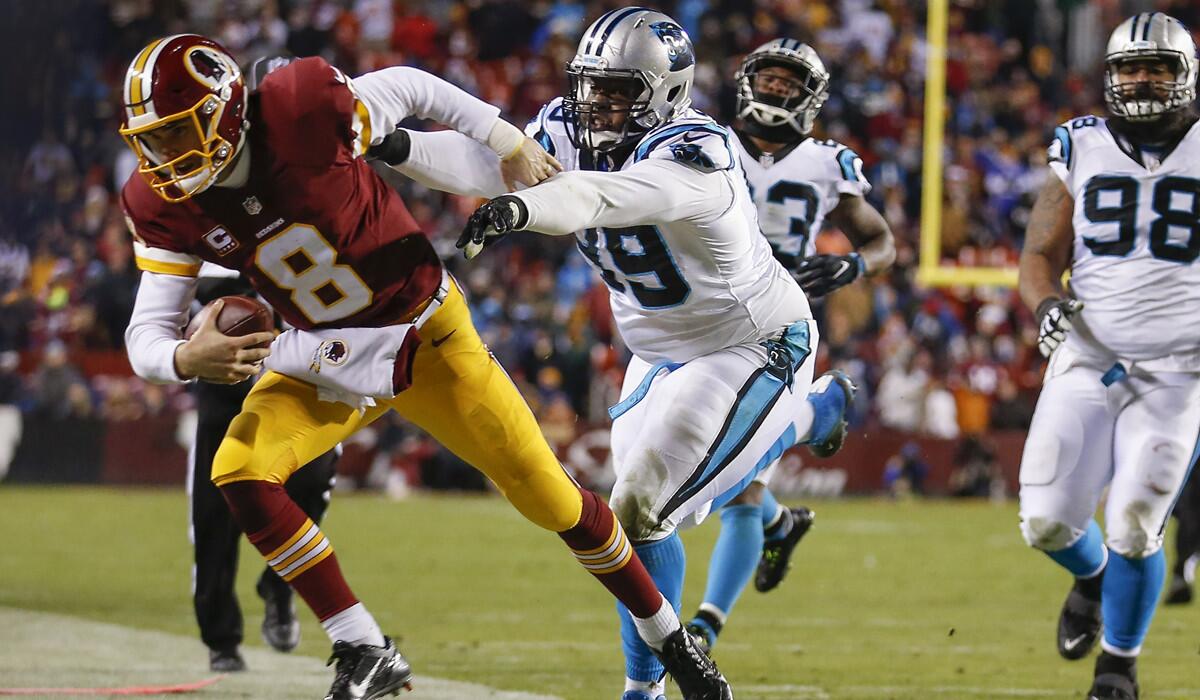 Washington Redskins quarterback Kirk Cousins (8) is forced out of bounds by Carolina Panthers defensive tackle Kawann Short (99) during the second half on Monday.