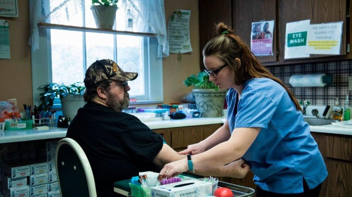 A patient has blood drawn at a community health center in Burton, W. Va.