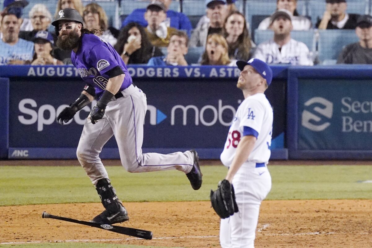 The Rockies' Charlie Blackmon runs after hitting a two-run homer off Dodgers reliever Jimmie Sherfy in the 10th inning.