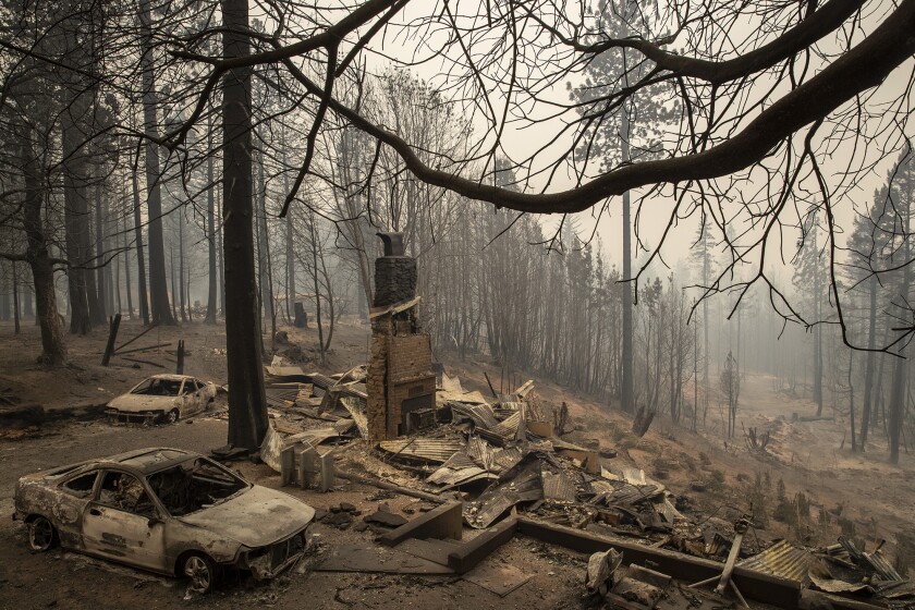 A home smolders in ruins in the aftermath of the Bear fire in Brush Creek