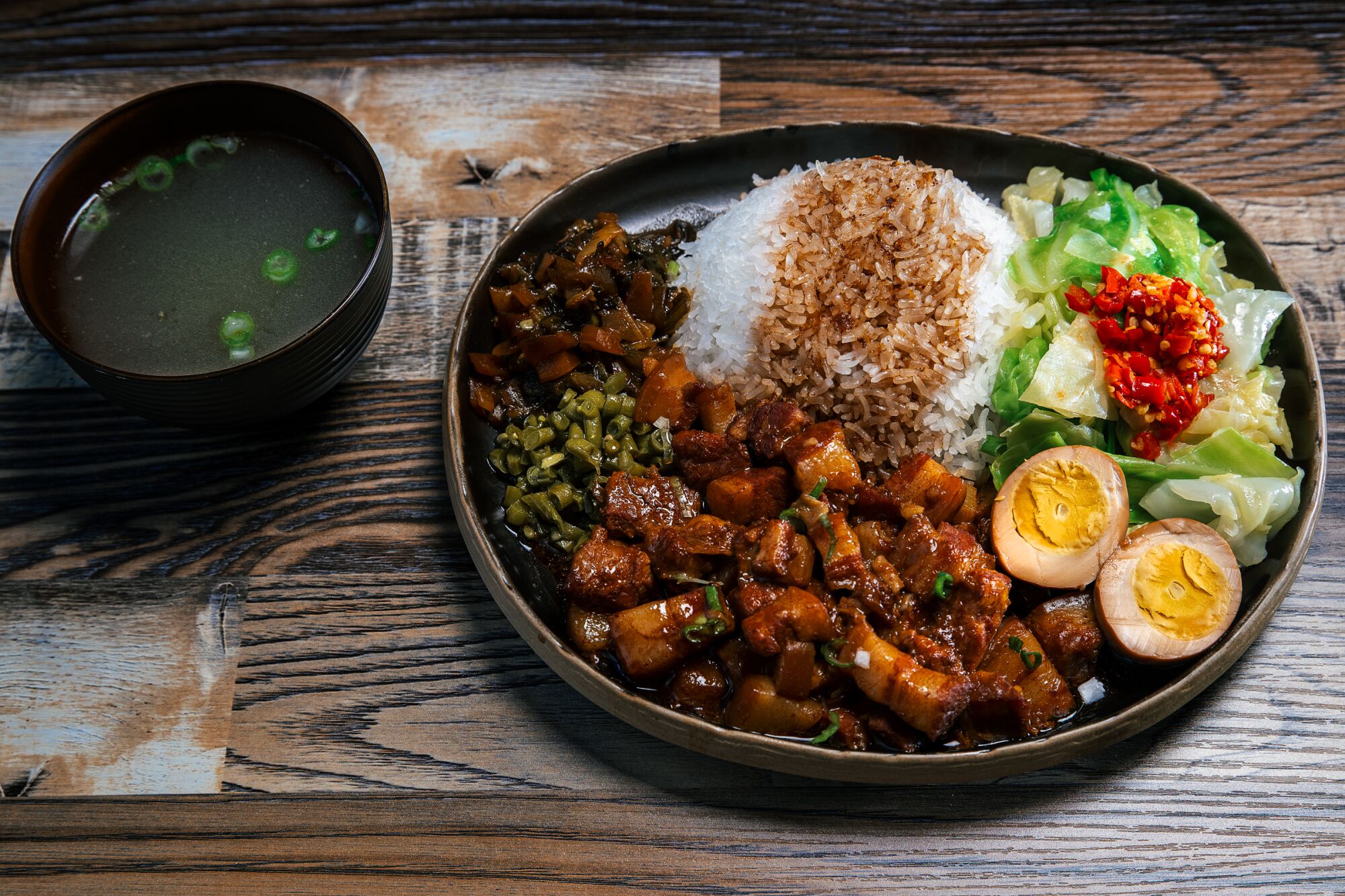 Dish with rise, pork, an egg and veggies