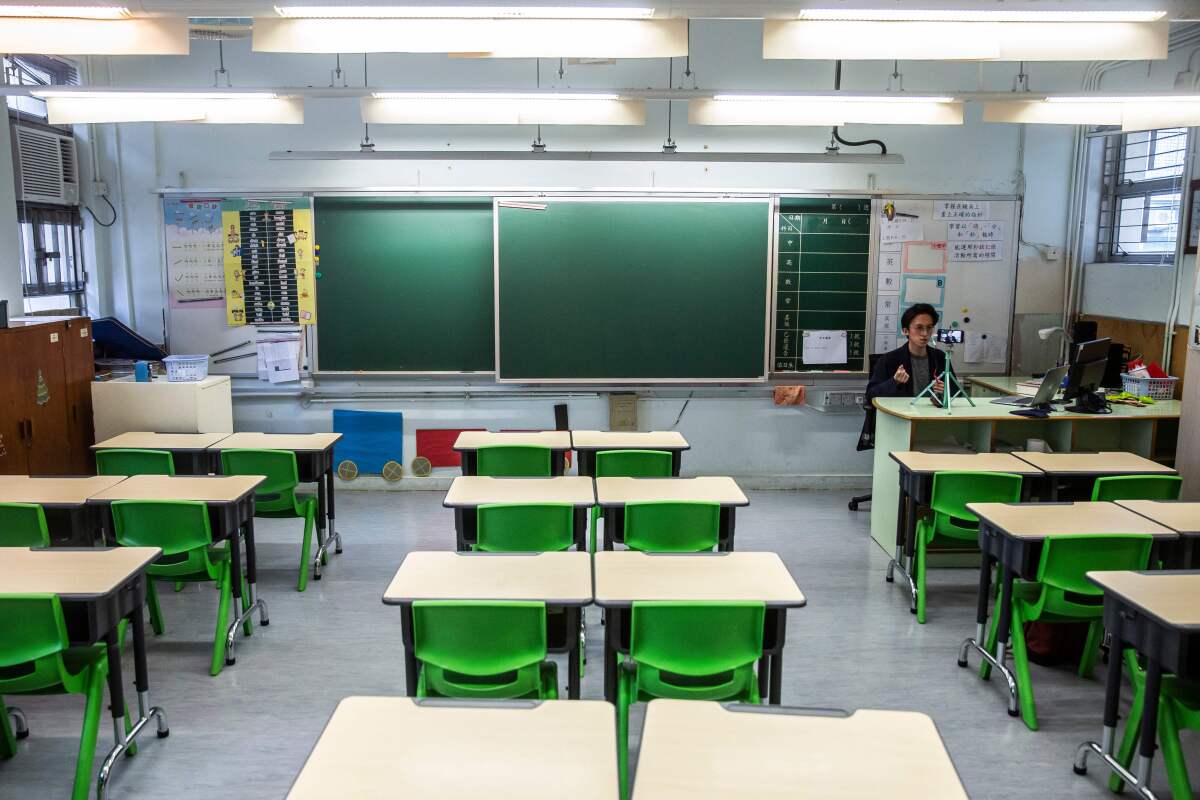 A teacher in Hong Kong records a video lesson for students who have had classes suspended due to the coronavirus.