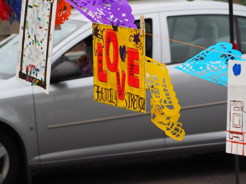 Cars drove around the St. Leo's parking lot looking at artwork made by local kindergarten to 12th grade students.