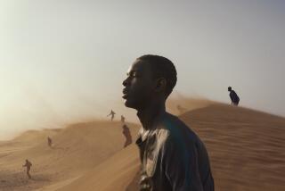 A teenager walks through a desert.