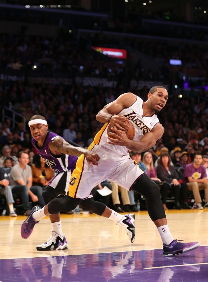 Lakers forward Xavier Henry, who led all scorers with 21 points, spins to the basket as Kings guard Isaiah Thomas reaches for the steal on Sunday at Staples Center.