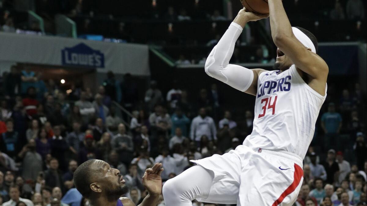 Clippers' Tobias Harris shoots the go-ahead and eventual game-winning basket against Charlotte Hornets' Kemba Walker during the second half on Tuesday.