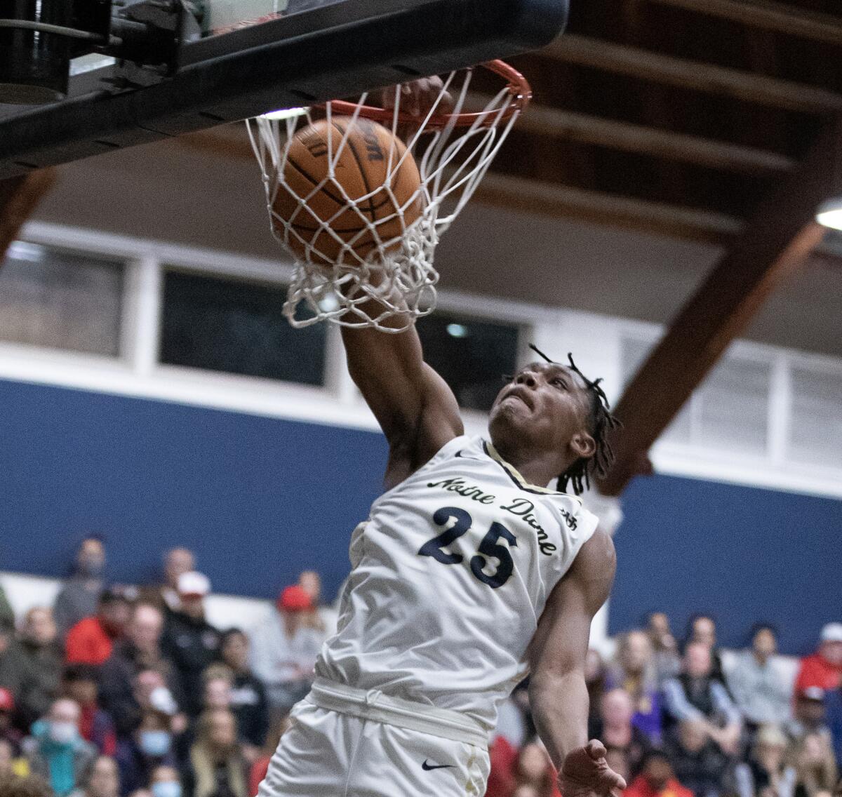 Notre Dame's Mercy Miller dunks the ball as two Harvard-Westlake players watch.