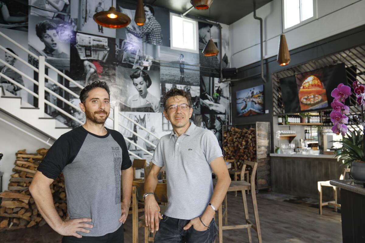 John Carlo Ferraiuolo, left, a partner and general manager, and Mario Cassineri, culinary director and managing partner of the new Italian restaurant, Blade1936 in the original Blade-Tribune and News building on Seagate Drive in Oceanside, built in 1936, and designed by famed architect Irving Gill. It is now home to the the restaurant, which has a newspaper-theme that celebrates newspapers, and especially the ones that once called the building home. Photographed September 24, 2019, in Oceanside, California.