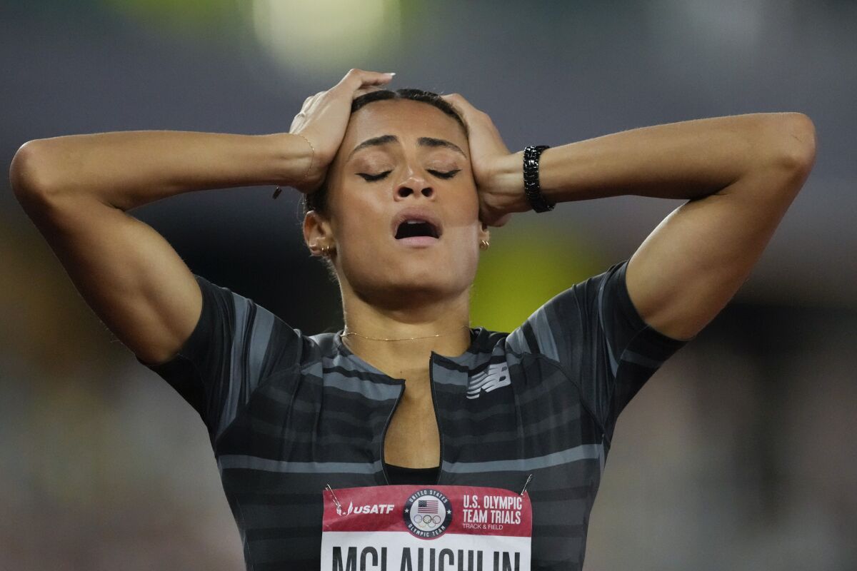 FILE - In this June 27, 2021, file photo, Sydney McLaughlin reacts after setting a new world record in the finals of the women's 400-meter hurdles at the U.S. Olympic Track and Field Trials in Eugene, Ore. The playbook for athletes provides a guide to a "safe and successful Games" for the Tokyo Olympics. It's filled with "cannots" and "do nots," meaning a once-in-a-liftetime opportunity will be a whole lot less fun. (AP Photo/Ashley Landis, File)