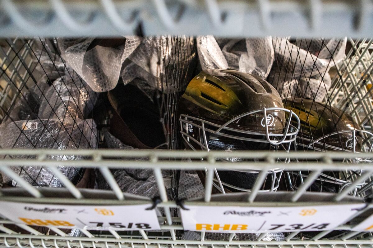 Catchers masks and other various Padres' equipment wait before being loaded onto trucks bound for spring trianing.