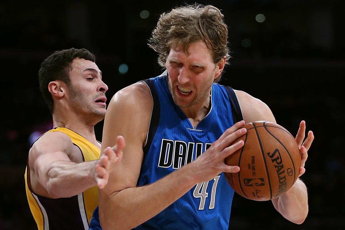 Mavericks forward Dirk Nowitzki dribbles into position against Lakers forward Larry Nance Jr. during second half of a game on Jan. 26.