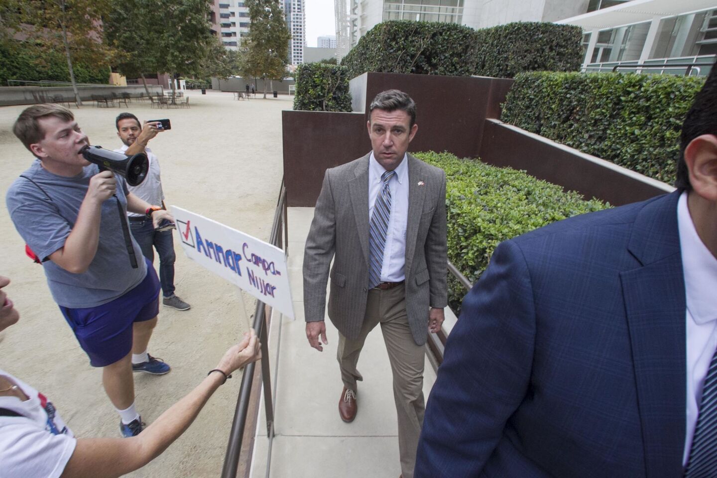 Protesters heckled Rep. Duncan Hunter Jr. as he walked up the ramp to the new courthouse building in downtown San Diego.