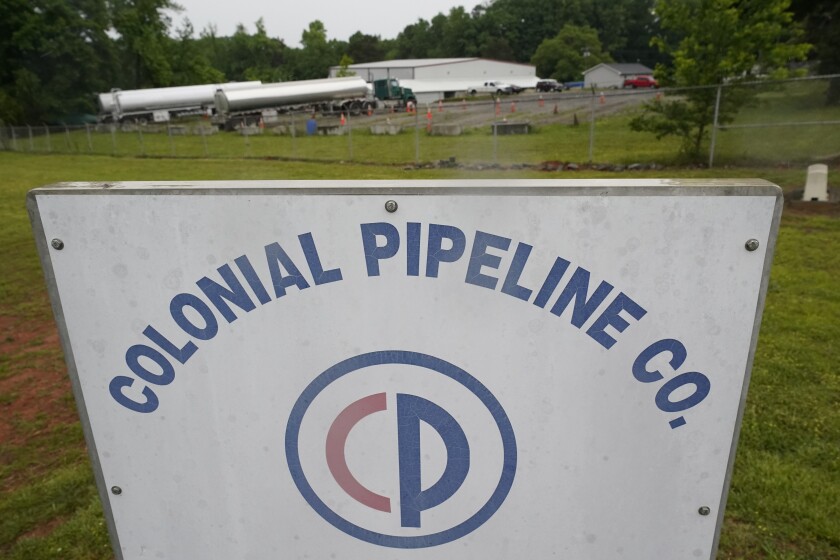 Tanker trucks are parked near the entrance of Colonial Pipeline Company Wednesday, May 12, 2021, in Charlotte, N.C. Several gas stations in the Southeast reported running out of fuel, primarily because of what analysts say is unwarranted panic-buying among drivers, as the shutdown of a major pipeline by hackers entered its fifth day. (AP Photo/Chris Carlson)