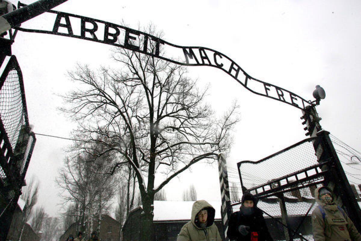 Visitors walk through the gates of the former Nazi concentration camp of Auschwitz in southern Poland.