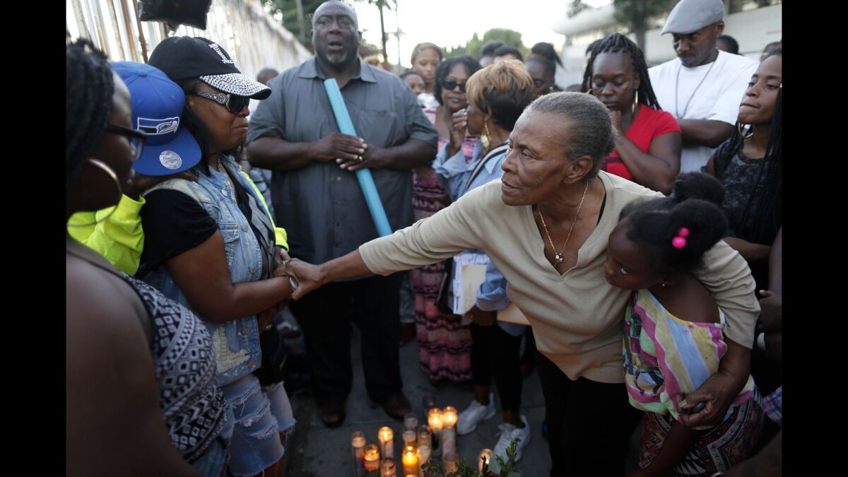 Family and friends gather for a vigil for 16-year-old Elijah Galbreath, who was gunned down Sunday afternoon in Watts.