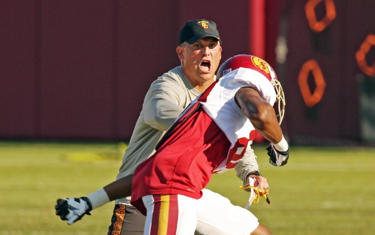 The USC Trojans resumed practice Tuesday under interim Coach Clay Helton.
