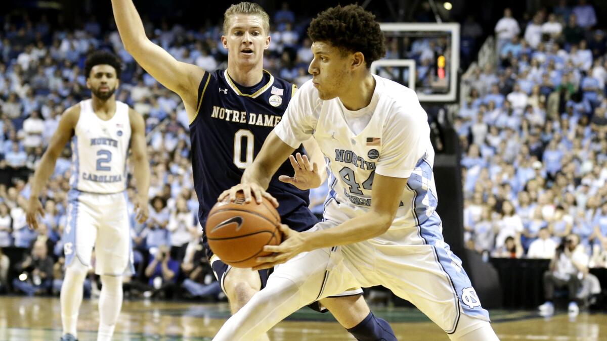 North Carolina's Justin Jackson prepares to pass as he's defended by Notre Dame's Rex Pflueger (0) defends during the first half Sunday.