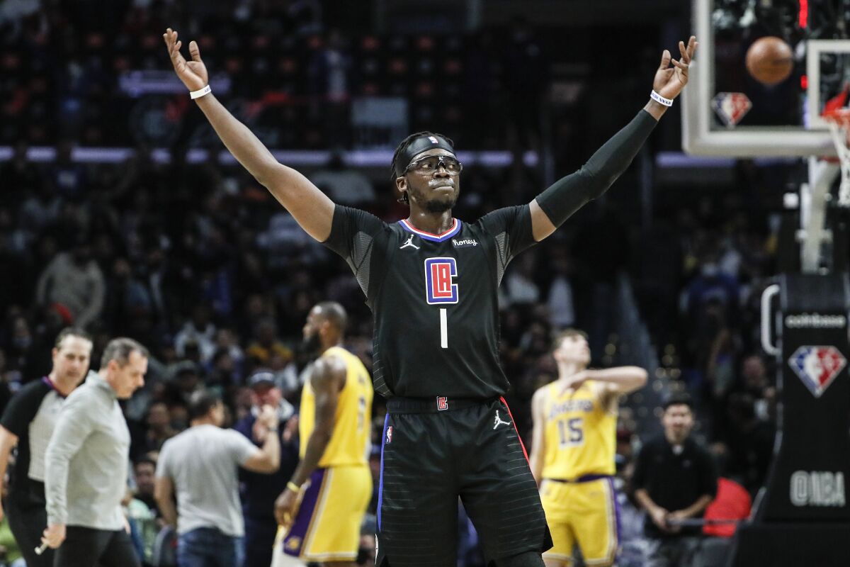 Clippers guard Reggie Jackson encourages fans to cheer.