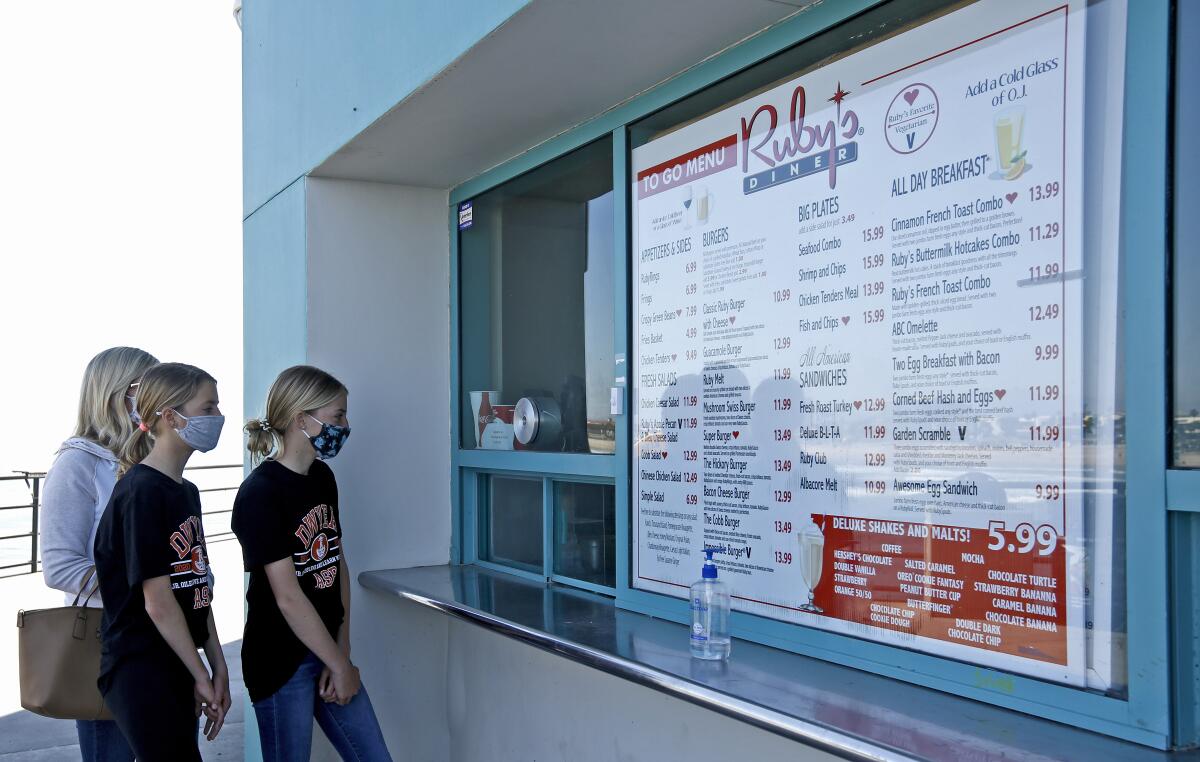 Customers place their order at the Ruby's on the Huntington Beach Pier on Friday.