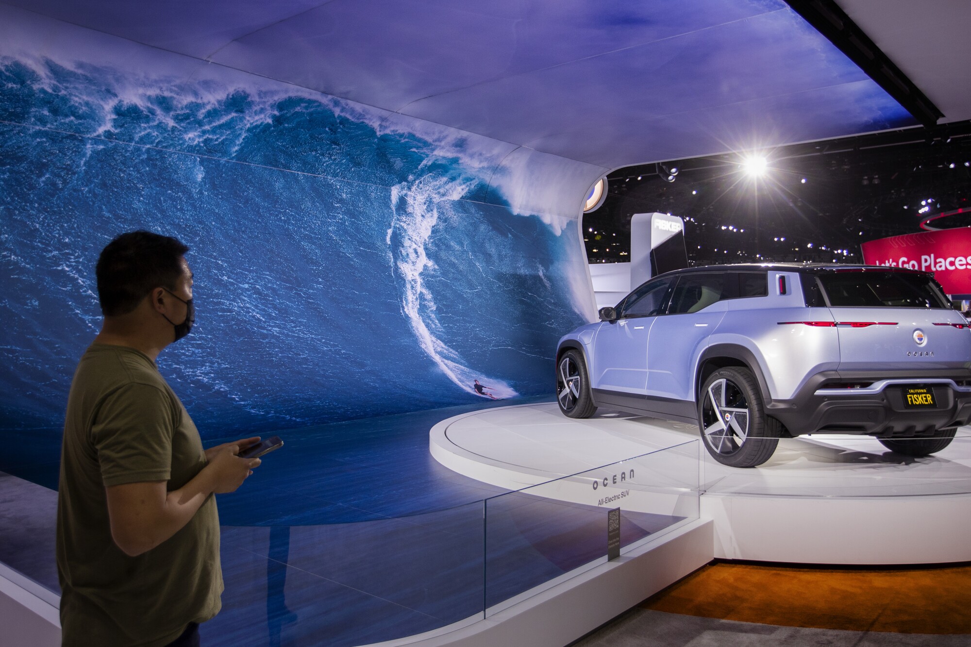 Car enthusiasts view the new Fisker Ocean all-electric vehicle at the Los Angeles Auto Show.