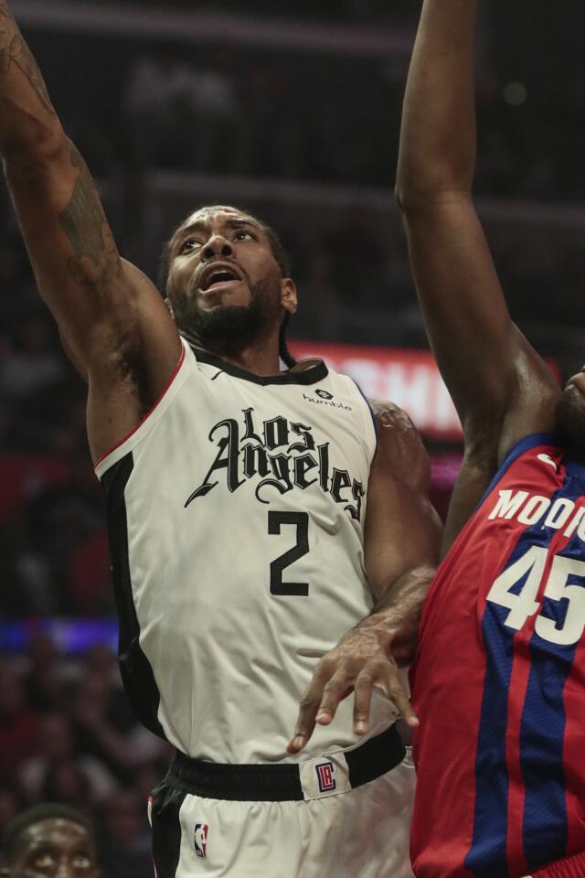 Clippers forward Kawhi Leonard, left, shoots over Detroit Pistons forward Sekou Doumbouya during the first half.
