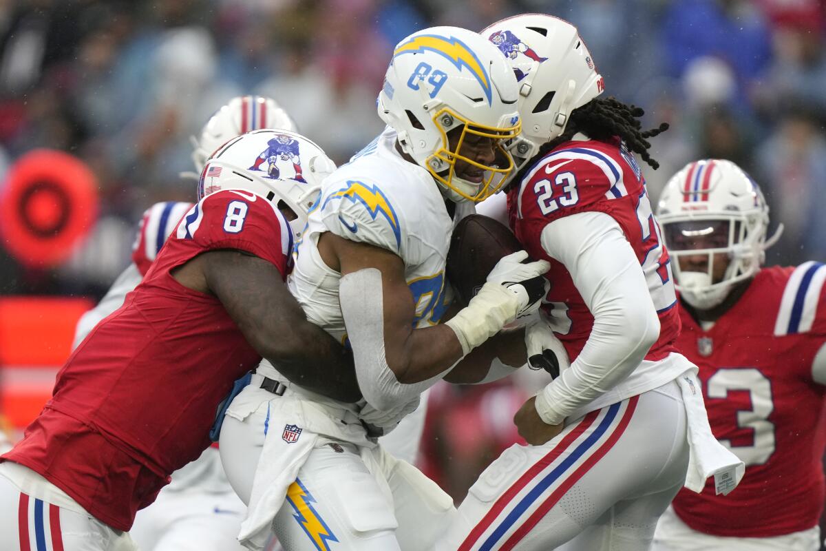 Chargers tight end Donald Parham Jr. tries to push through New England Patriots defenders.