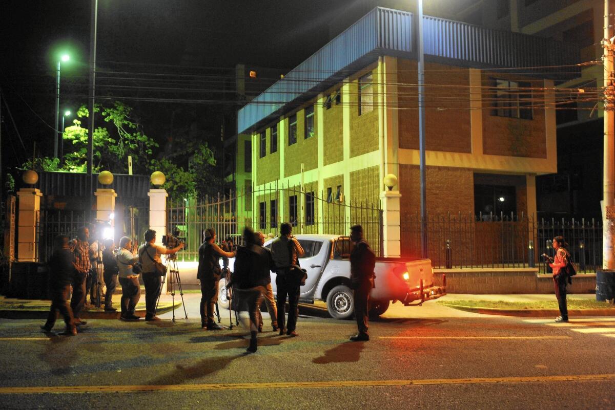 Journalists await information at police headquarters in San Salvador.