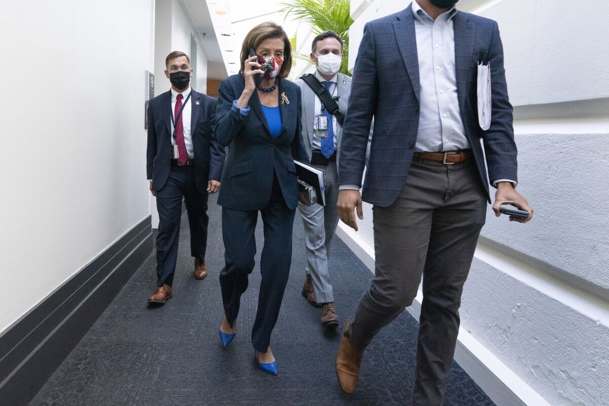 FILE - In this Oct. 1, 2021, file photo House Speaker Nancy Pelosi of Calif., talks on her phone as she arrives for a meeting with House Democrats on Capitol Hill in Washington. (AP Photo/Jacquelyn Martin, File)