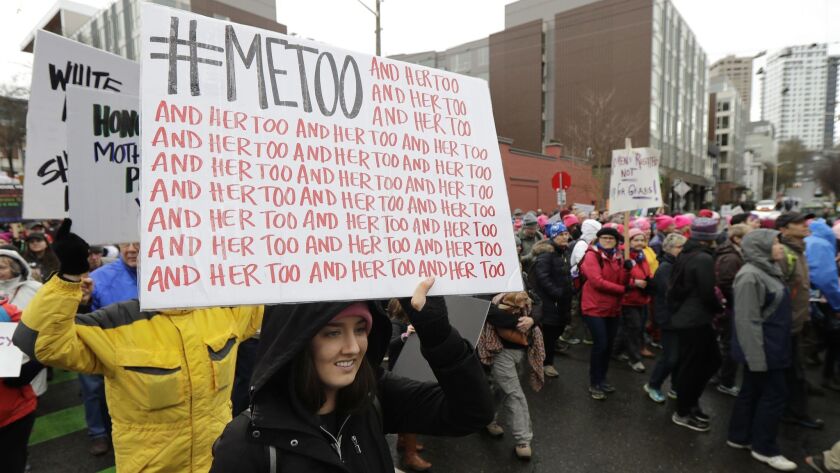 A marcher in Seattle in January carries a sign with the hashtag #MeToo, used by people speaking out against sexual misconduct.