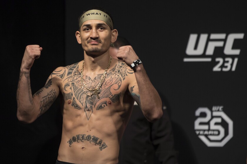 UFC featherweight champion Max Holloway poses during the weigh-in for his mixed martial arts bout against Brian Ortega at UFC 231, in Toronto on Friday, Dec. 7, 2018. (Chris Young/The Canadian Press via AP)