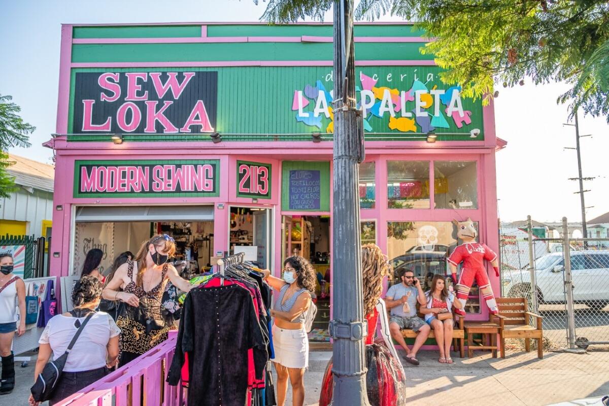 Customers browse merchandise outside Sew Loka during Walk The Block in Barrio Logan on Aug. 22, 2020
