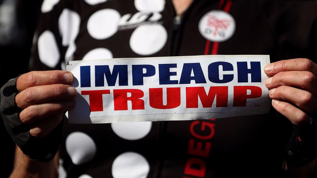 An attendee holds a sign calling for the impeachment of President Trump during a rally held by Tom Steyer in San Francisco on Oct. 24.