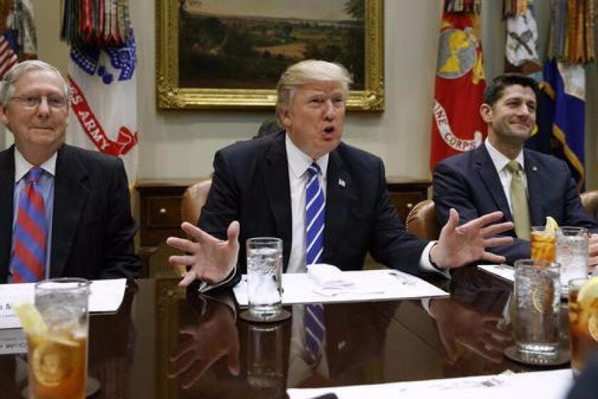 President Trump is flanked by Senate Majority Leader Mitch McConnell (R-Ky.), left, and House Speaker Paul D. Ryan (R-Wis.) at the White House
